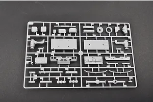 A grey plastic sprue containing various unpainted model parts for a 1/35 scale military vehicle kit, laid out on a dark grey surface.