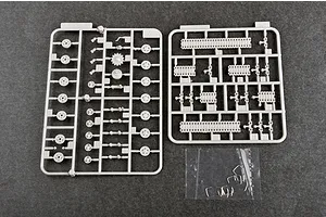 Two grey plastic model kit sprues and a small bag of metal parts for a 1/72 scale tank model on a dark grey background.