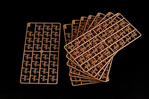 Several brown plastic model tank track sprues arranged on a black background.