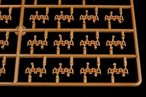 A close-up view of a brown plastic model kit sprue containing multiple individual tank track links for a 1/35 scale model.