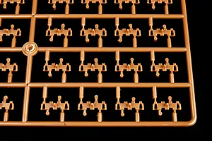 A brown plastic sprue containing multiple individual tank track links for a 1/35 scale model kit.
