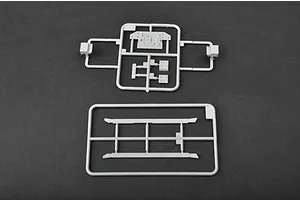 Two grey plastic model kit sprues containing various small tank parts on a dark grey background.
