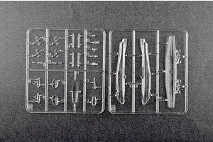 Two clear plastic model kit sprues containing small aircraft parts on a dark grey background.