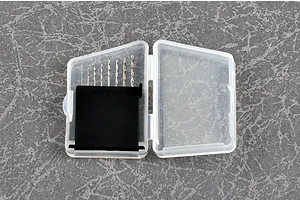 A set of eight small craft drill bits arranged by size in a clear plastic storage case with a black insert.