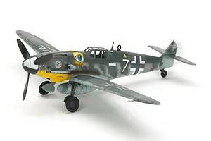A fully assembled and painted 1/72 scale Tamiya Messerschmitt Bf109 G-6 model aircraft, featuring a grey camouflage scheme, yellow nose, and eye decal.