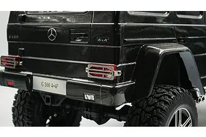 Close-up of a black RC Mercedes-Benz G 500 model car showing the rear taillight protector grill installed over the red taillight lens.