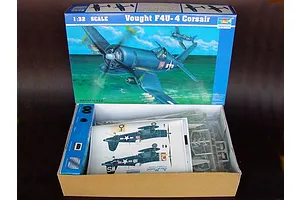 Open box of Trumpeter 1/32 scale Vought F4U-4 Corsair plastic model kit showing instruction manual, decals, and plastic parts trees.