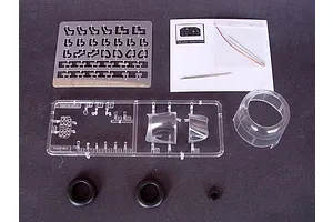 Components for a 1/32 scale Trumpeter Vought F4U-4 Corsair model kit, including photo-etched parts, clear canopy pieces, rubber tires, and small metal rods.