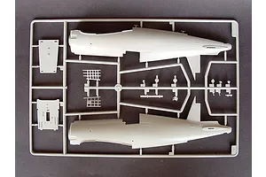 A grey plastic sprue containing fuselage halves and small interior parts for a 1/32 scale model aircraft kit.