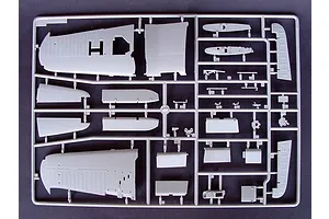 A grey plastic sprue containing various aircraft model parts, including wing sections and control surfaces, for a 1/32 scale model kit.