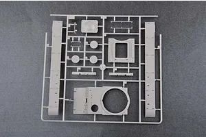 A grey plastic sprue containing various model tank parts, including hull sections and turret components, for a 1/35 scale model kit.