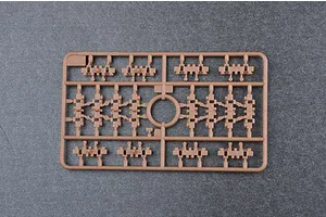 A brown plastic sprue containing small tank track link parts for a 1/35 scale model kit.