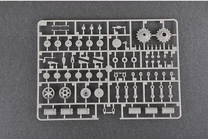 A grey plastic sprue containing various tank model parts, including road wheels, sprockets, and suspension components for a 1/35 scale model kit.