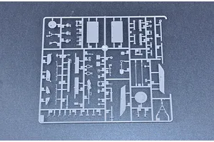 A grey plastic sprue containing various small model parts for a 1/35 scale military vehicle kit.