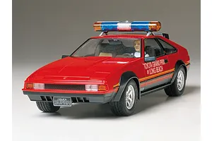 A 1/24 scale Tamiya model kit of a red Toyota Celica Supra Long Beach GP Marshal car with a roof-mounted light bar.