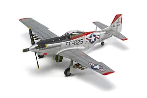 A high-angle studio shot of a fully assembled and painted 1/48 scale North American F-51D Mustang model aircraft on a white background.