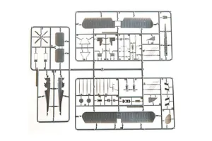 A top-down view of grey plastic model aircraft parts still attached to their sprues on a white background.