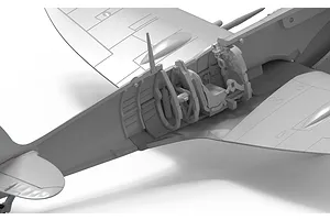Close-up of the cockpit interior assembly of an unpainted plastic model Spitfire aircraft kit.