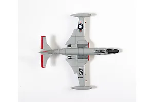 Top-down view of an assembled 1/72 scale Academy F2H-3 Banshee model aircraft painted in grey with red tail accents and US Navy markings.