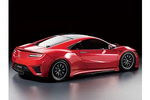 A rear three-quarter studio shot of a red Tamiya NSX RC car model on a dark background.