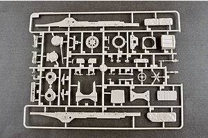 A light grey plastic sprue containing various model parts for a 1/35 scale military vehicle kit, laid out on a dark grey surface.