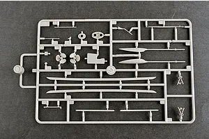 A grey plastic model kit sprue containing various ship parts including propellers, shafts, and structural components on a dark grey background.