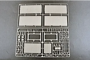 Two light grey plastic model kit sprues containing various flat panels and structural components for a 1/35 scale model.