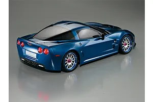 Rear three-quarter view of a metallic blue Killerbody 1/10 scale Corvette GT2 RC car body shell on a grey background.