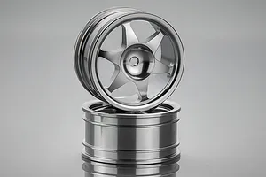 Two silver aluminium 6-spoke RC crawler rims stacked on a reflective grey surface.