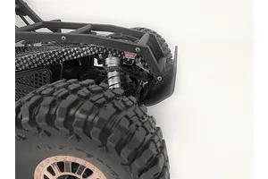 Close-up of the front end of a Losi Lasernut RC car featuring a T-Bone Racing front bumper installed on the chassis.