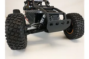 A T-Bone Racing front bumper installed on a 1/10 scale Losi Lasernut RC rock racer, viewed from a low front angle.