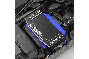 A black aluminium Yeah Racing servo mount installed over a blue RC servo inside a Traxxas 4-Tec chassis.