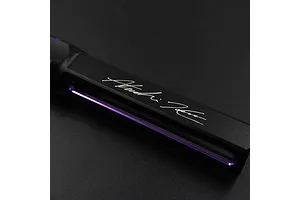 Close-up of a black and purple aluminium hex driver handle with a signature engraved on the side.