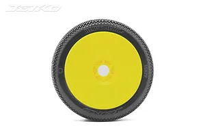 A single Jetko Red Devil 1/8 scale RC buggy tyre mounted on a bright yellow dish rim, viewed from the side against a white background.