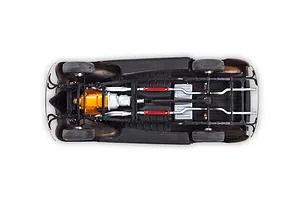 Underside view of a 1/24 scale model car chassis showing the engine, exhaust system, and drivetrain details.