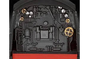 Close-up of the detailed black and gold locomotive cab interior from a Revell 1/87 scale model kit.