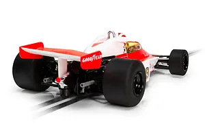 Rear three-quarter view of a Scalextric 1/32 scale McLaren M23 slot car in white and red livery on a track.