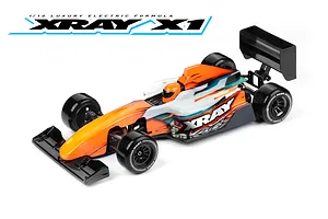 A studio shot of an XRAY 1/10 scale electric formula RC car with an orange, white, and black livery, featuring a driver figure and black wheels.