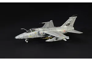 A side-view of a completed Italeri 1/72 scale AMX Ghibli model aircraft, painted in grey with Black Cats squadron markings on a black background.