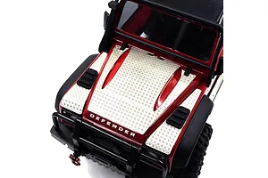 A close-up high-angle shot of a red RC crawler hood fitted with silver stainless steel diamond plate engine cover accessories.