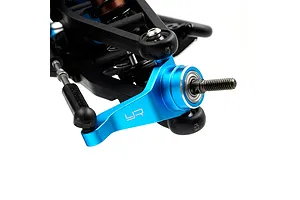 A blue anodized aluminium RC steering hub installed on a black suspension arm assembly.
