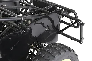 Close-up of a black plastic dust guard installed on the rear chassis of an RC buggy, showing the protective panel mounted near the rear wheel and roll cage.
