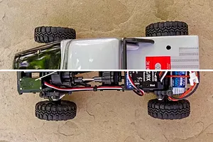 Top-down view of an Element RC Enduro24 Ecto rock crawler, showing the body shell on top and the internal chassis components below.