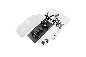 Yeah Racing Onisiki Kodama 1/24 scale RC drift car kit including chassis, clear body shell, instruction manual, and small parts bags.