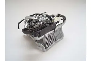 A detailed 1/24 scale plastic model engine assembly for a Nissan GT-R, featuring silver and black components against a plain white background.