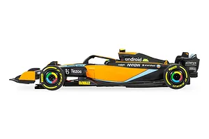 Side profile view of a Scalextric 1/32 scale McLaren MCL36 Formula 1 slot car in papaya orange and black livery.