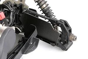 A close-up of a carbon fibre suspension arm guard installed on the front assembly of an RC vehicle.