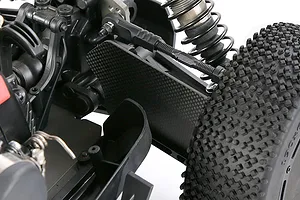Close-up of a carbon fibre front suspension arm guard installed on an RC buggy, showing the textured plate mounted near the wheel and shock absorber.