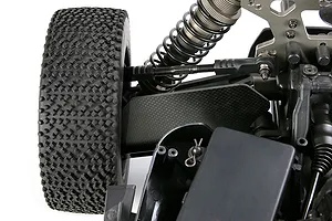 Close-up of a carbon fibre suspension arm guard installed on an RC buggy front suspension assembly.