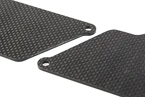 Close-up of two black carbon fibre RC suspension arm guards with a woven texture and mounting holes.